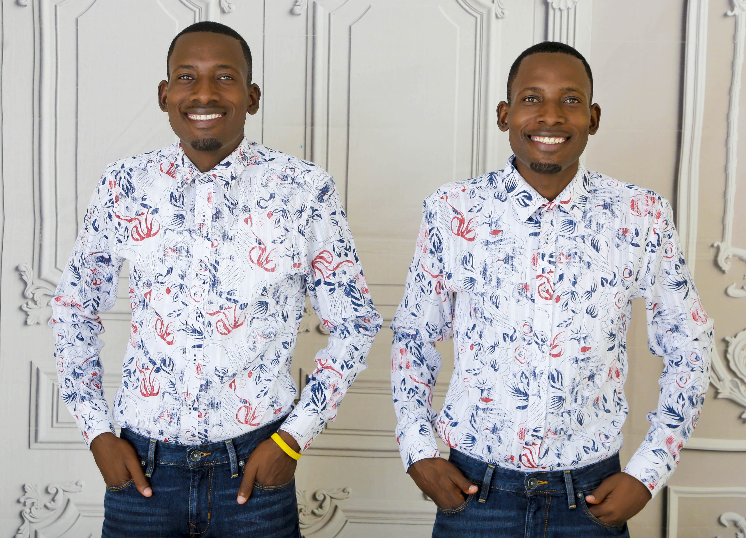 Two men standing side by side in matching floral shirts