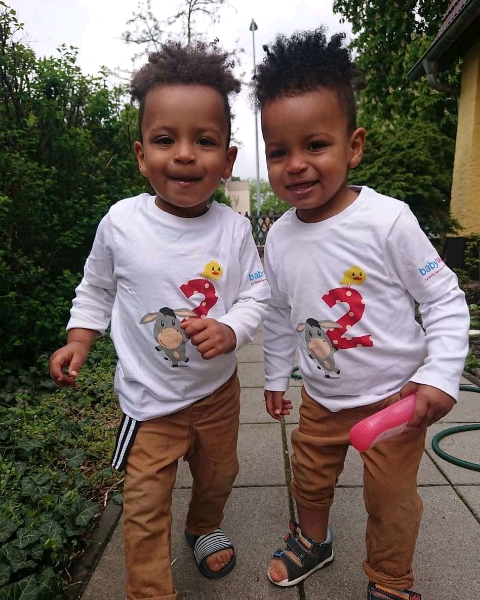 Two children standing together outdoors