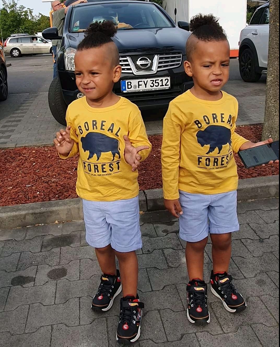 Two children in matching yellow T-shirts