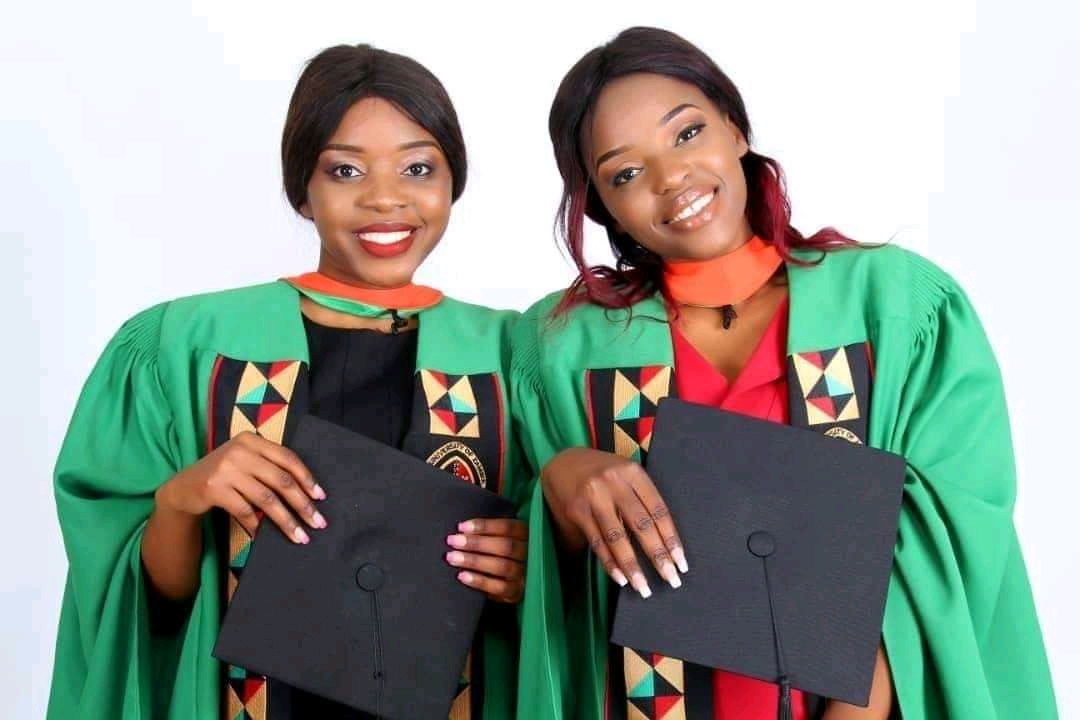 Together in green graduation gowns