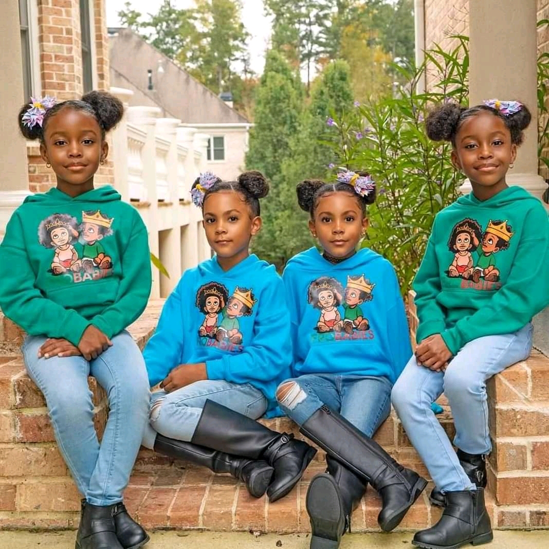 Four children in matching green and blue tops